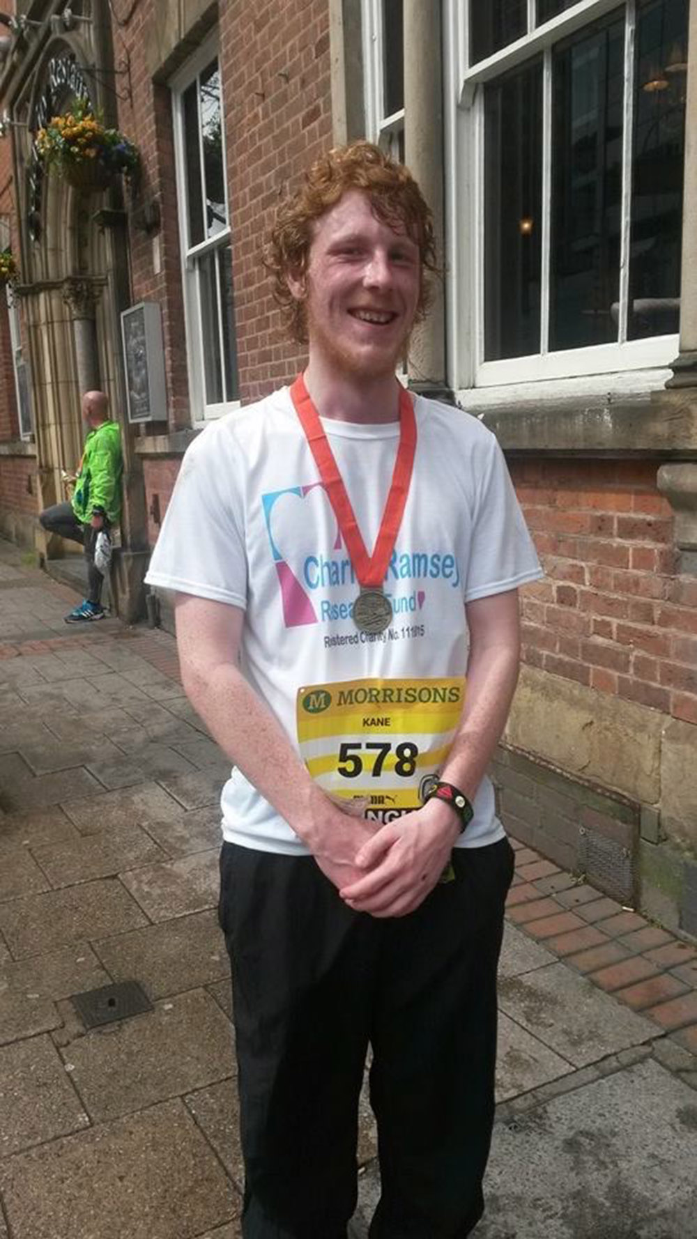 Man with medal after finishing the Birmingham Half Marathon